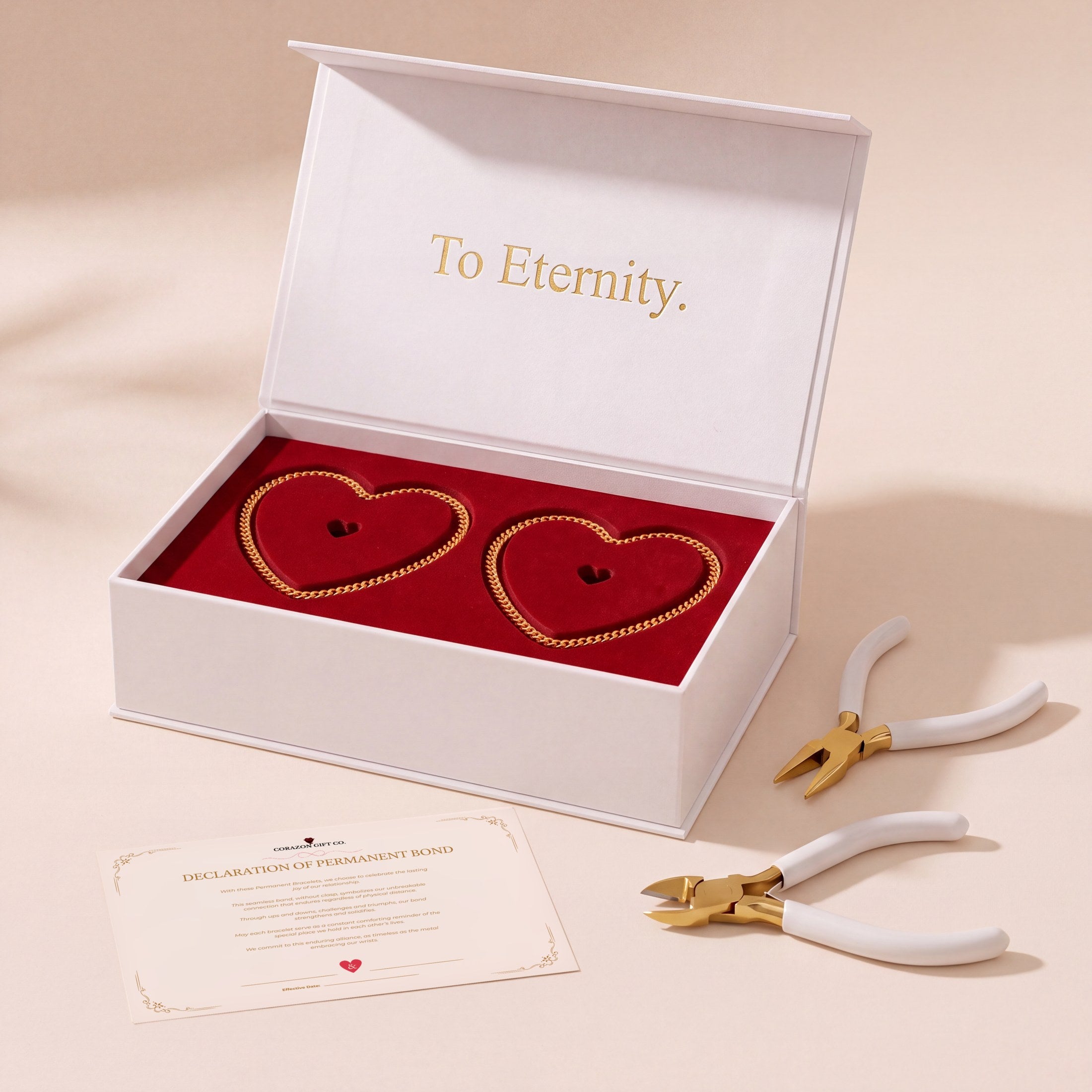 The Eternal Bracelet Kit open: two gold bracelets laid as hearts on red velvet, with the pliers, wire cutters and the Declaration card